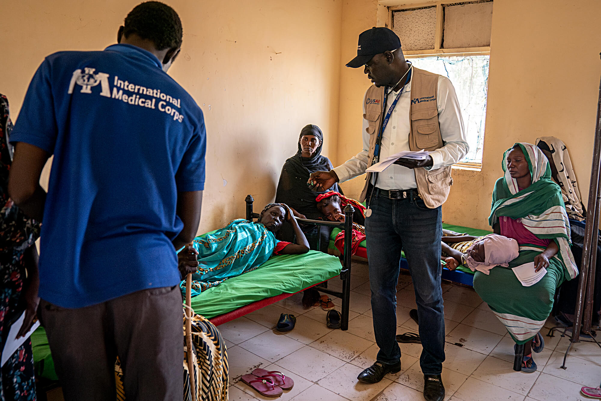 Dr. William and other staff members meet with patients at the International Medical Corps health clinic in Renk, South Sudan.